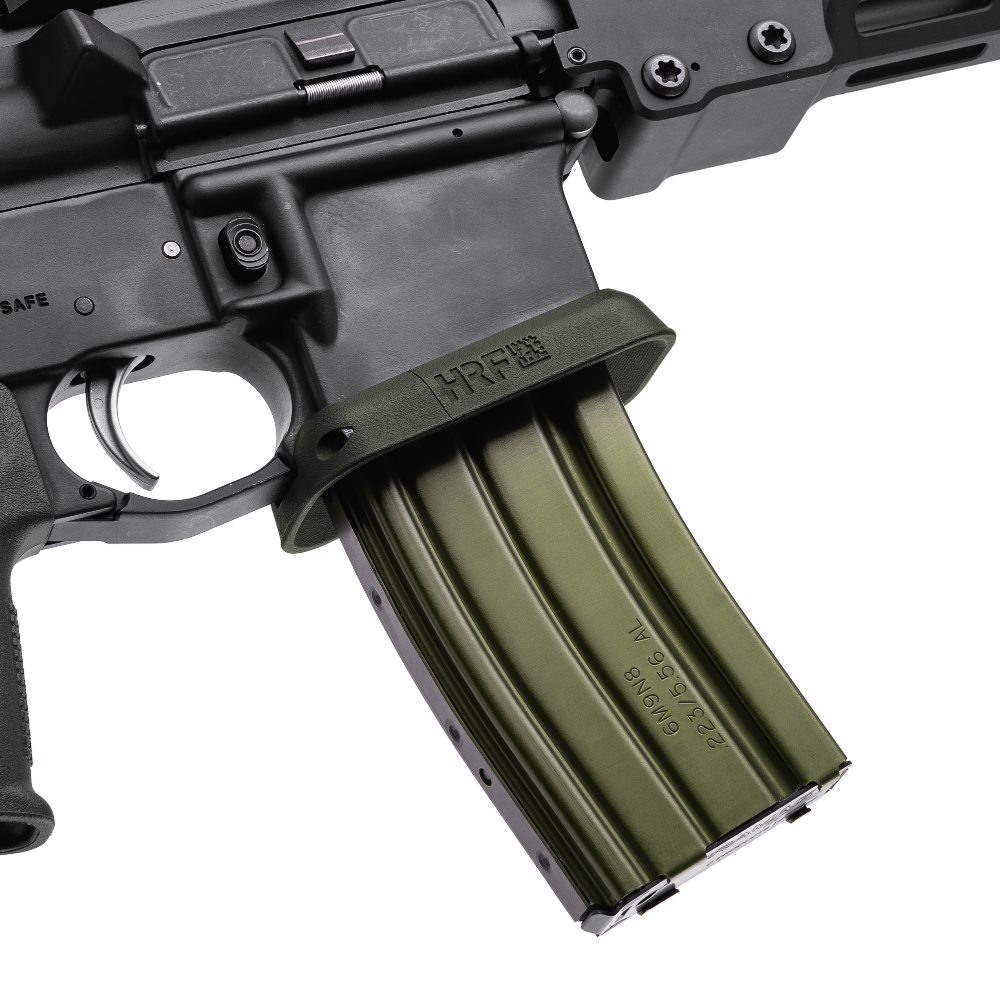 AR-15 with HRF Concepts RCM Rifle Combat Magwell in OD green, featuring a flared funnel design for faster magazine changes and enhanced rifle control, shown with a matching green aluminum STANAG magazine inserted