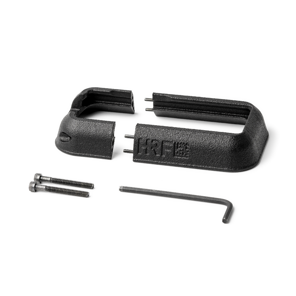 HRF Concepts RCM Rifle Combat Magwell in black shown disassembled with included hardware and hex key, featuring a two-piece flared funnel design for easy installation on AR-15 platforms